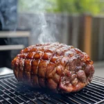 What's the easiest thing to cook in a smoker? Juicy chicken pieces smoking on a grill.