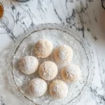 What's the difference between amaretto and amaretti? Glass of amaretto with amaretti cookies.